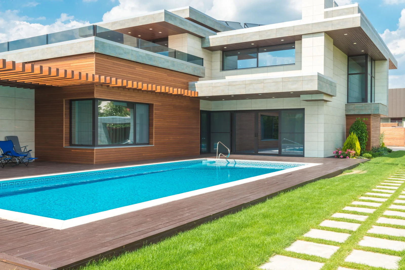 Contemporary residence with a pool, glazed walls, and landscaped garden.