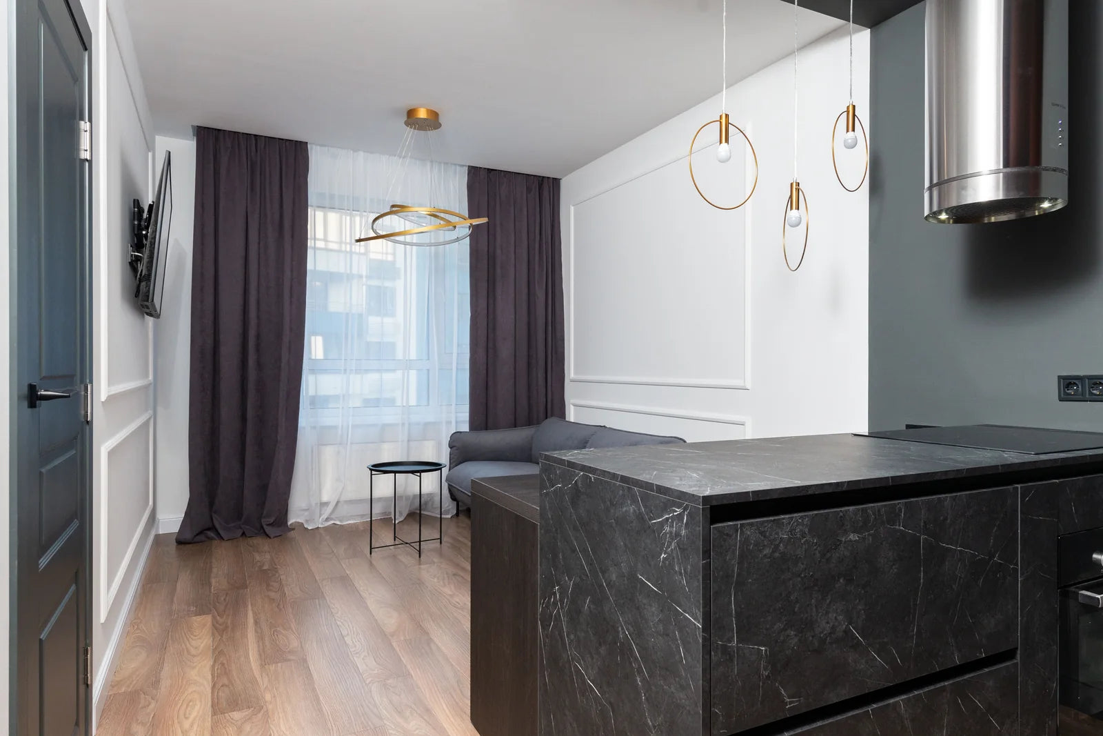 A refined apartment interior with stone surfaces and soft natural light.